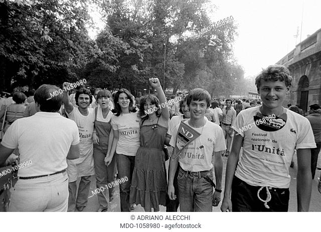 Festa dell'Unità. Young people greeting with raised fist at Festa dell'Unità in Parco Sempione. Milan, September 1979
