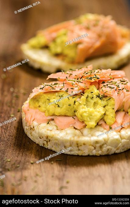 Salmon with avocado cream on rice crackers