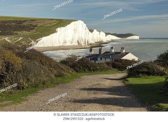 Afternoon on the coast in East Sussex, England. Coastguard Cottages and the cliffs of Seven Sisters in the distance