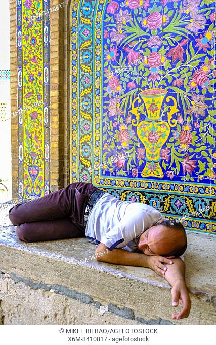 Man sleeping on the door. Agha Bozorg mosque. Kashan, Iran. Asia