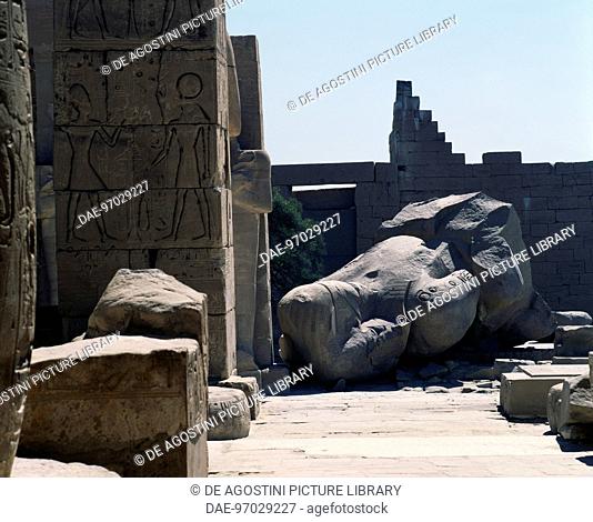 The remains of the Colossus of Ramesses II, statue in syenite (red granite), first courtyard ofthe Ramesseum (funerary temple of Ramses II)