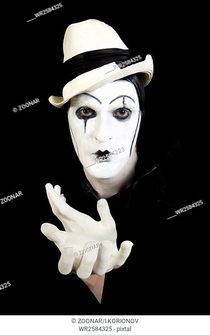 face and hands of mime with dark make-up