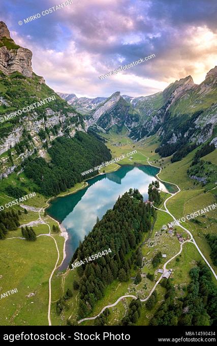 View of Seealpsee and the surrounding mountains at sunset. Canton of Appenzell, Alpstein, Switzerland, Europe