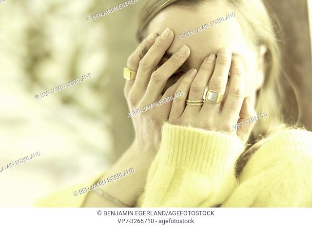 aristocratic woman covering face with hands, in Munich, Germany