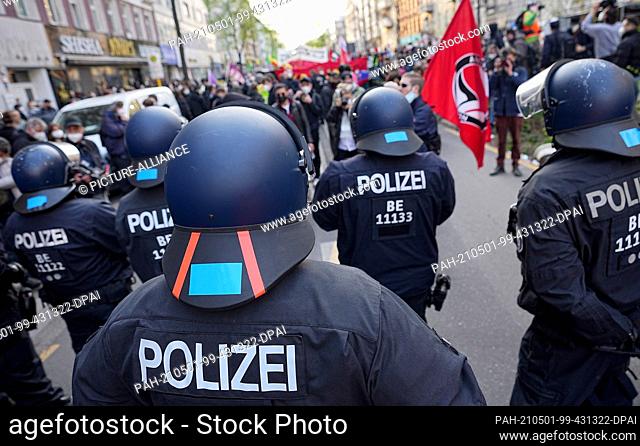 01 May 2021, Berlin: Police officers observe the participants in the demonstration procession of left-wing and radical left-wing groups under the motto...
