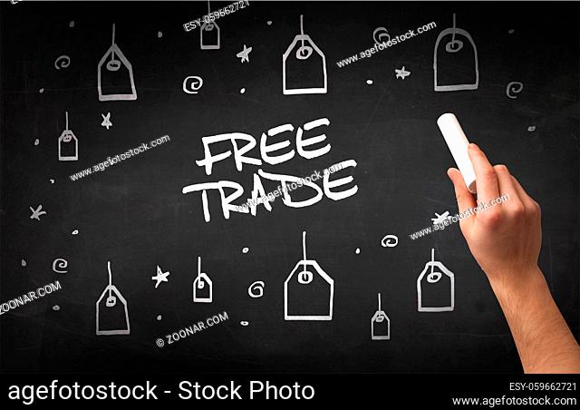 Hand drawing FREE TRADE inscription with white chalk on blackboard, online shopping concept