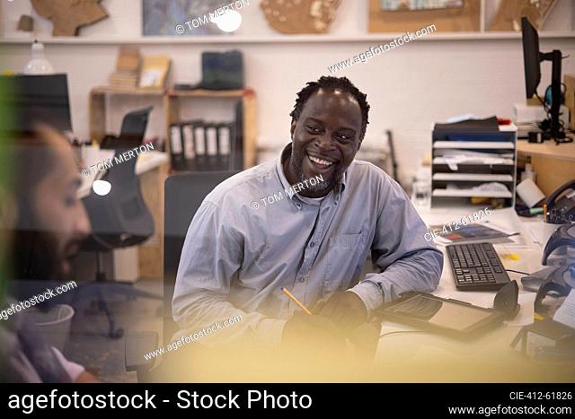 Laughing businessman working in office
