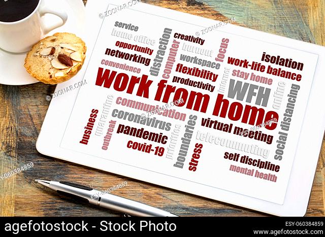 work from home word cloud on a digital tablet with a cup of coffee, social distancing, self quarantine and stay-at-home order during covid-19 coronavirus...