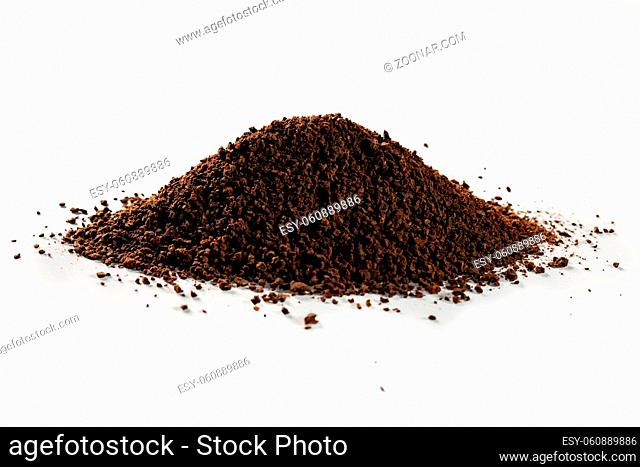 Isolated roasted and minced coffee or particles of coffee beans on white background