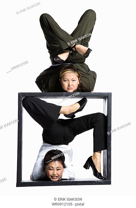Two female contortionist businesswomen