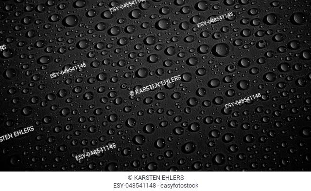Fresh water drops on black background texture