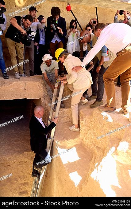 Queen Mathilde of Belgium descends from a ladder during a visit to the excavation site of Dayr-al-Barsha on the third day of a royal visit to Egypt