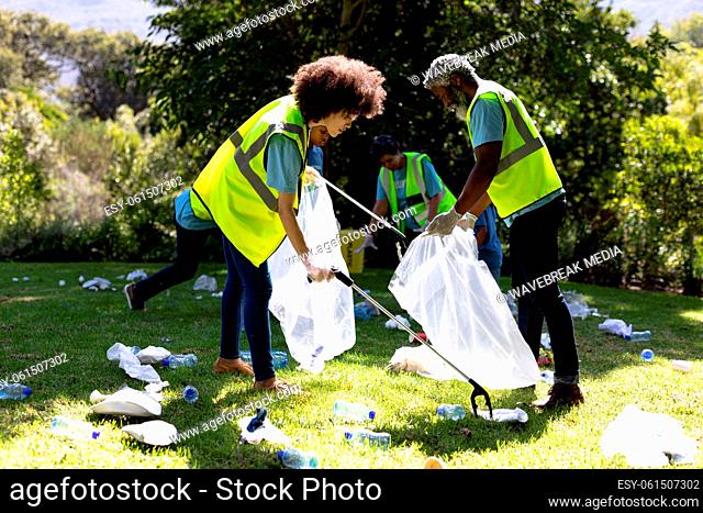 Multi-generation mixed race family collecting garbage