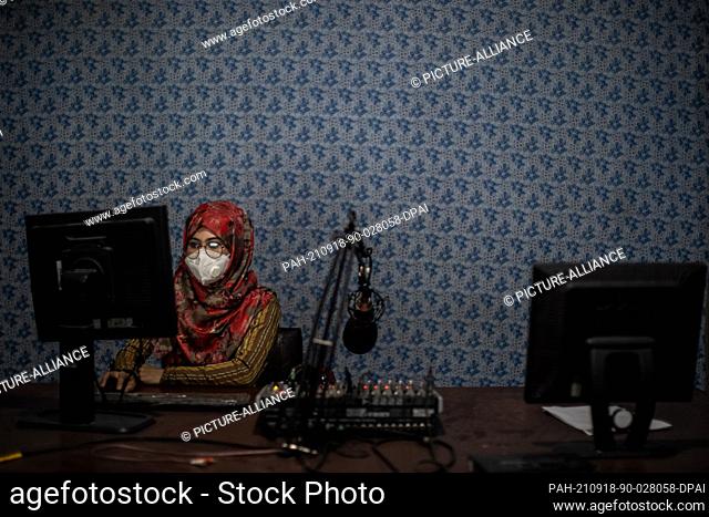 18 September 2021, Afghanistan, Kunduz: 20-year old Afghani radio journalist Nadia Safi sits on a computer at the studio of Radio Zohra (English: Venus)
