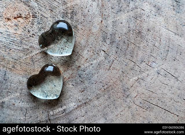 Two transparent hearts on the rough surface of an old stump. Perfect Valentine's Day greeting card background