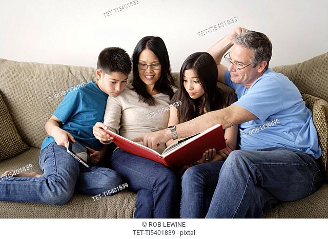 Family watching photo album together