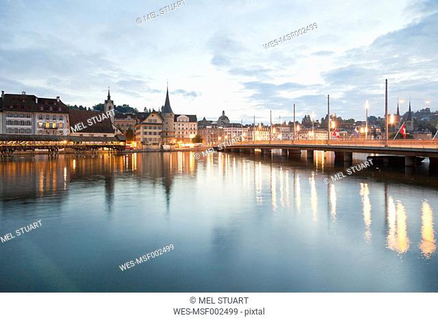Switzerland, Lucerne, View of Schweizerhofquai Bridge with water tower and old town in morning light
