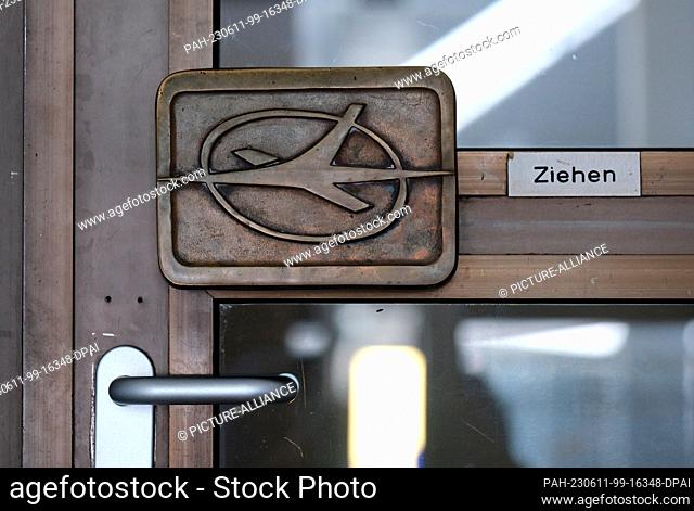 11 June 2023, Saxony, Schkeuditz: A door handle with the logo of the GDR airline Interflug, taken at the airport festival on a building at Leipzig-Halle Airport
