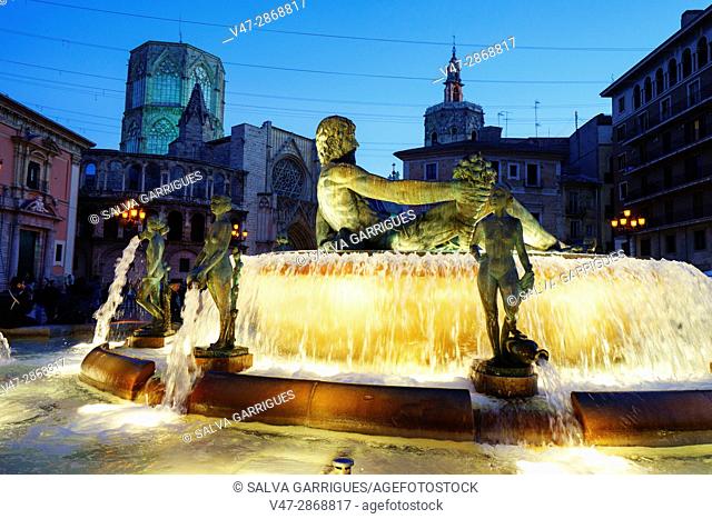 Fountain of the Turia in the Plaza de la Virgen, background the basilica of the Virgin of the Desamparados, Valencia, Spain