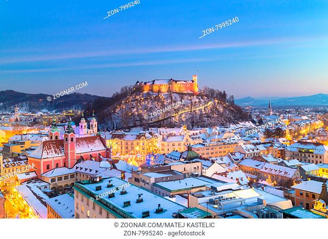 Aerial panoramic view of Ljubljana decorated for Christmas holidays. Roofs covered in snow in winter time. Slovenia, Europe