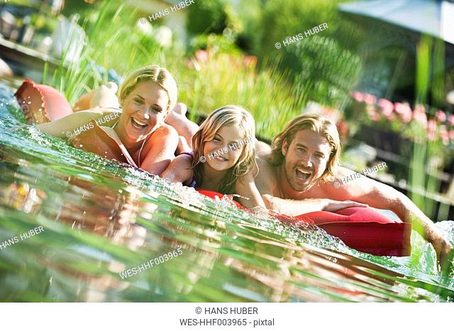 Austria, Salzburg County, Family on airbed in natural pool