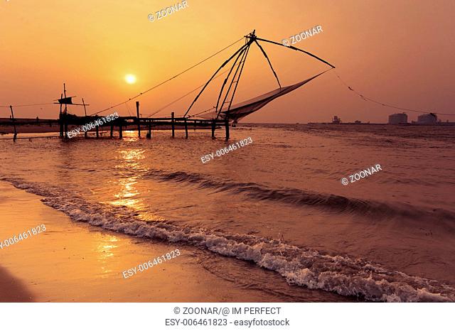 Sunset at tropical beach with chinese fishing nets