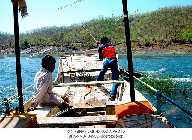 Two fisherman in boat Narmada river  ; Omkareshwar  ; Indore   ; Madhya Pradesh  ; India