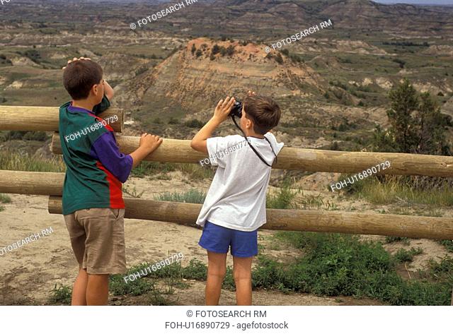 Theodore Roosevelt National Park, South Unit, North Dakota, overlook, Two boys looking at the view of the badlands from the overlook at the Painted Canyon...
