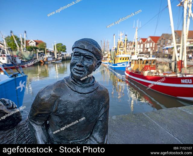 Bronze sculpture of a fisherman in the cutter harbour of Neuharlingersiel, Wangerland, East Frisia, Lower Saxony, Germany, Europe