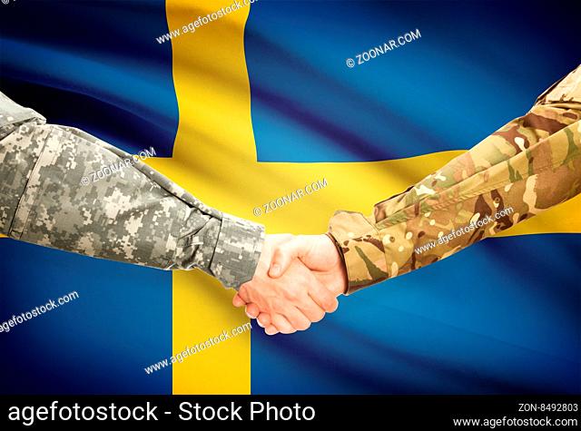 Soldiers shaking hands with flag on background - Sweden
