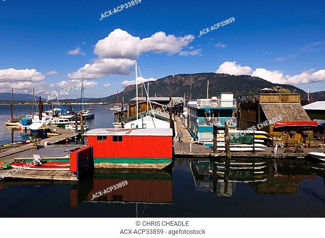 Floathomes and boats on marine floats at Cowichan Bay British Columbia. Kayak rental launch on floats