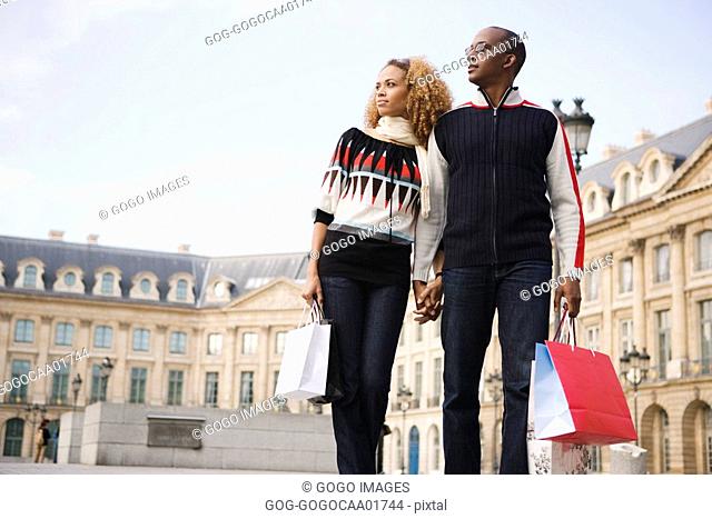 African couple carrying shopping bags