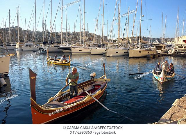 gondolas and taxi boats in the canal of Birgu, Three Cities. Valletta, Malta