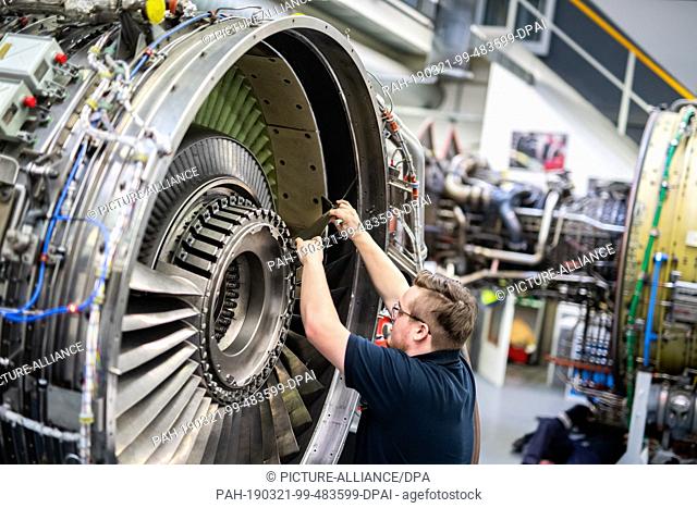 21 March 2019, Hamburg: A man is working on the engine of an aircraft in a Lufthansa Technik workshop. On the same day Lufthansa Technik's Annual-Pk takes place