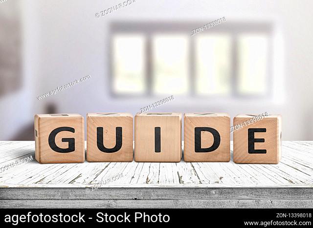Guide sign made of wood on a desk in a bright room with windows