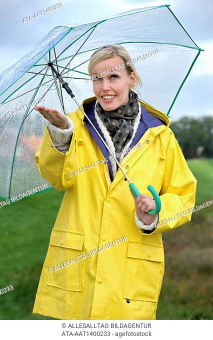 Woman walking in the rain with an umbrella