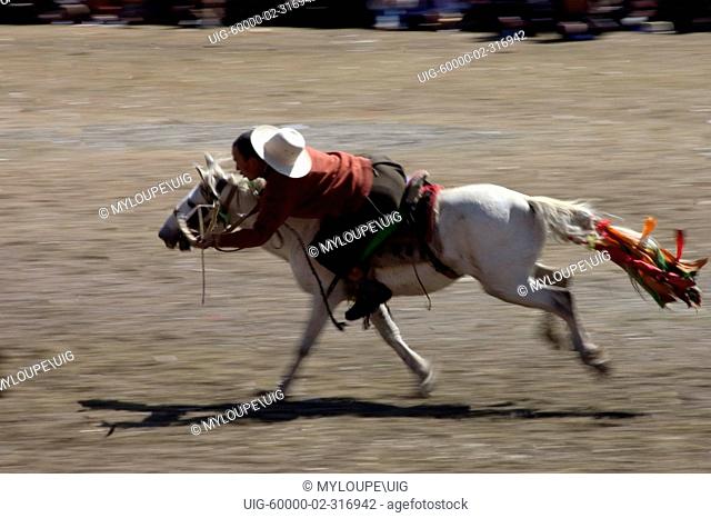 Khampa entertain the crowd in a rowdy horse race at the Litang Horse Festival - Kham, Sichuan Province, China, Tibet