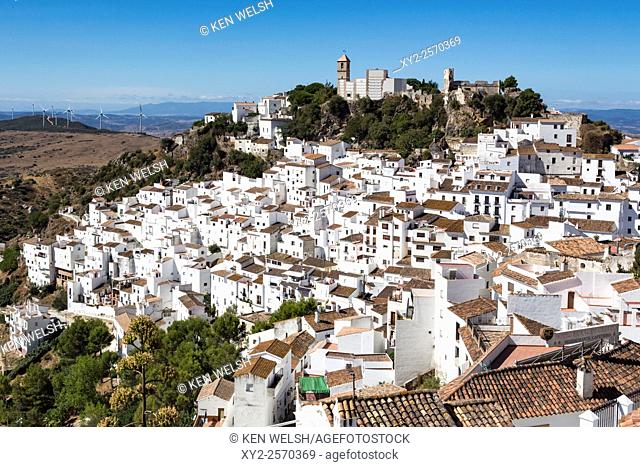 Casares, Malaga Province, Andalusia, southern Spain. View across village to the remains of the Arab castle and church, the Iglesia de la Encarnación