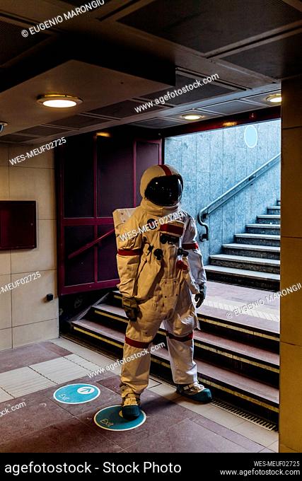 Male astronaut standing by staircase