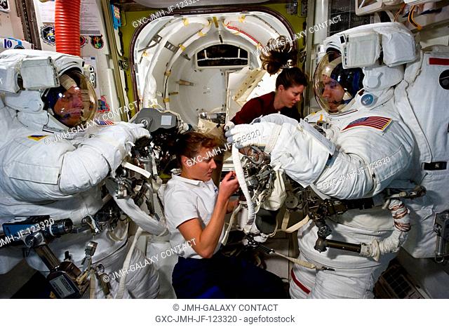 NASA astronauts Clayton Anderson (left) and Rick Mastracchio, both STS-131 mission specialists, attired in their Extravehicular Mobility Unit (EMU) spacesuits;...
