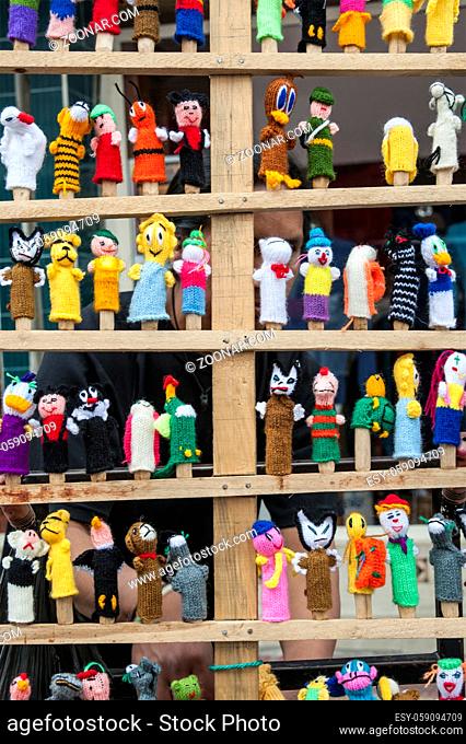 OTAVALO, AUGUST 4, 2012: Traditional ecuadorian textiles dolls are sold at the fair as usual on weekdays on the most famous markets in South America