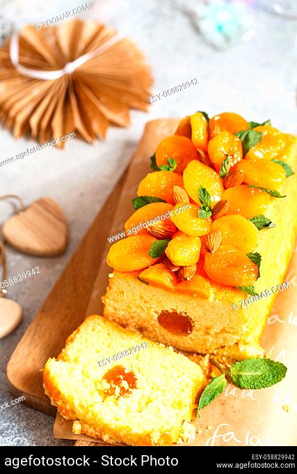 Orange Pound Cake flavored with freshly squeezed orange juice and zest decorated with dried apricots, mint leaves and almonds