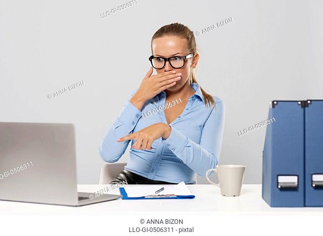 Shocked woman pointing at laptop, Debica, Poland