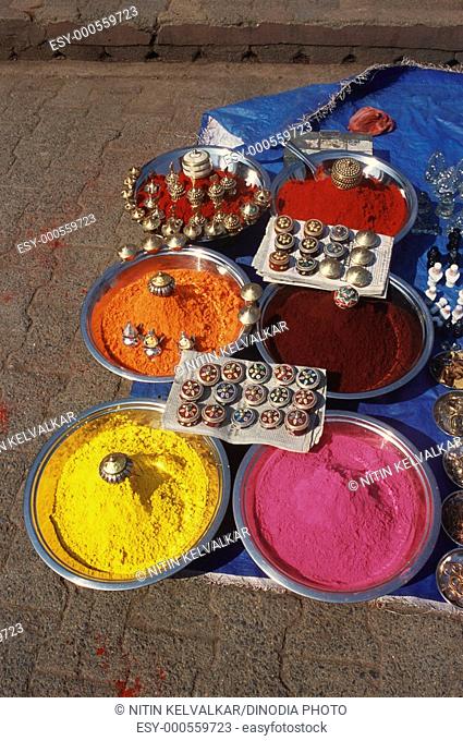 Colourful holy powder and containers boxes outside Ram Raja temple , Orchha , Madhya Pradesh , India