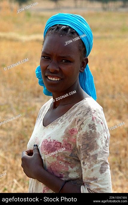 GREAT RIFT VALLEY, ETHIOPIA - NOVEMBER 16, 2014: Young Ethiopian woman on a field on November 23, 2014 in the Great Rift Valley, Ethiopia, Africa