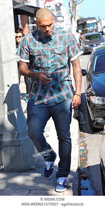 Chris Brown smoking while shopping with on-again off-again girlfriend Karrueche Tran in Hollywood Featuring: Chris Brown Where: Hollywood, California
