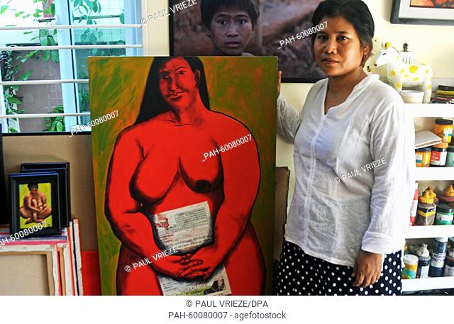Painter Sandar Khine presents one of her artworks in her workshop in Rangoon, Myanmar, 07 June 2015. She held her first exhibition in Rangoon two years ago and...