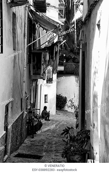 Mediterranean alley way between old houses and buildings black and white