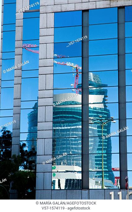 Titania Tower reflected on glass facade, Paseo de la Castellana. Madrid, Spain