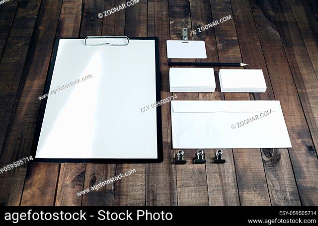 Blank corporate identity template on wood table background. Photo of blank stationery. Mock up for design portfolios. Responsive design mockup